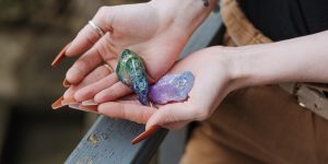 Crop woman showing opals in hands